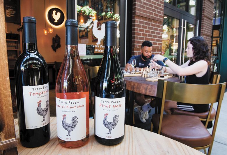 A couple enjoying Terra Pacem s sidewalk seating while sipping wine flights.