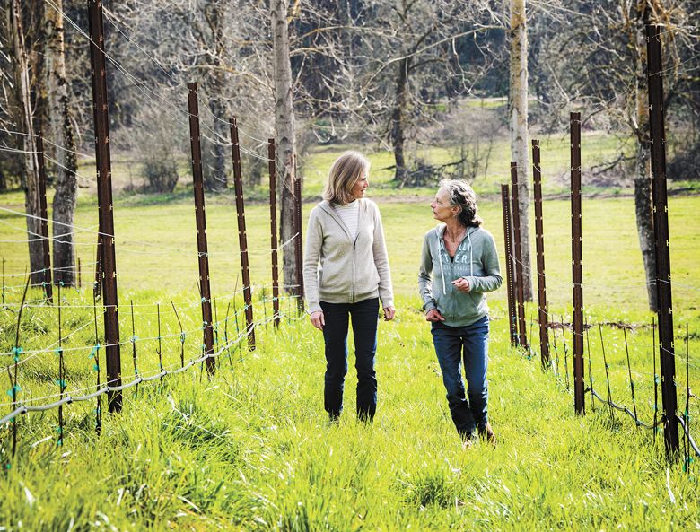 Caballus Cellars winemakers Isabelle Dutartre and Véronique Boss-Drouhin strolling through a vineyard. ##Photo by Kathryn Elsesser