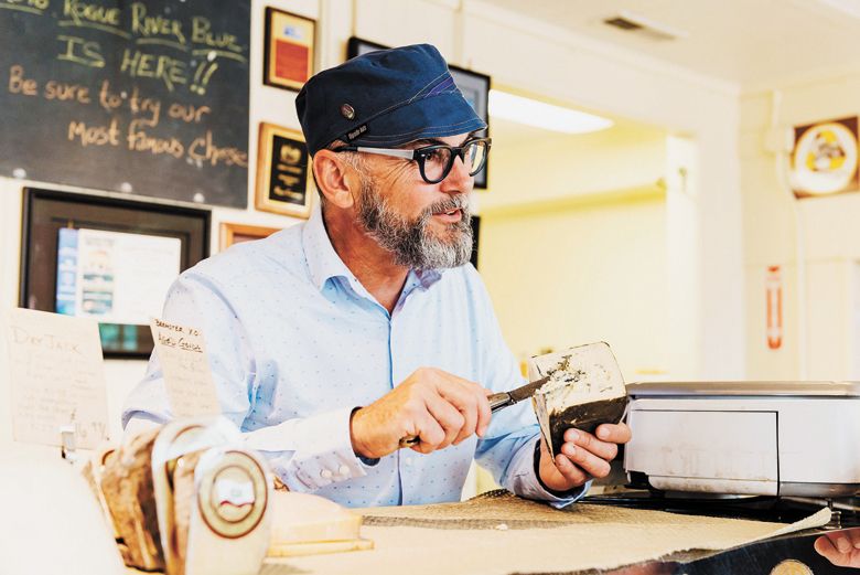 Known as “Mr. Blue,” Gremmels serving cheese at the creamery walk-up counter.##Photo PROVIDED