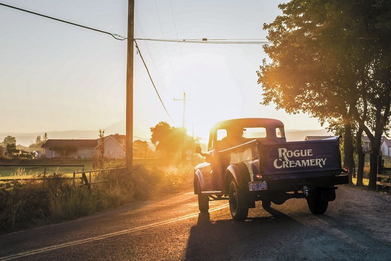 Bertha, the Rogue Creamery’s blue, 1948 Dodge pickup, driving into the sunset.##Photo CREDIT: Favoreat