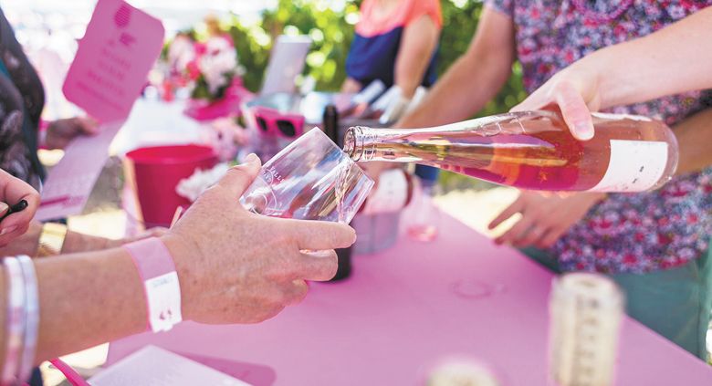 Guests enjoying pink rosé wine at the event.##Photo provided