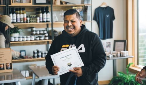 José Tejada smiles after receiving his AHIVOY program certificate of completion. ##Photo by Sean Carr