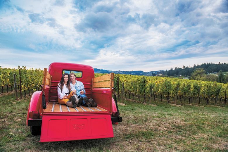 Anacréon Winery owners, Danell and Kipp Myers, enjoy time in their Chehalem Mountains estate vineyard. Their red 1947 Ford pickup is the winery mascot, perfect for photos and enjoyed by visiting guests. ##Photo BY CAROLYN WELLS KRAMER Anacréon Winery owners, Danell and Kipp Myers, enjoy time in their Chehalem Mountains estate vineyard. Their red 1947 Ford pickup is the winery mascot, perfect for photos and enjoyed by visiting guests. ##Photo BY CAROLYN WELLS KRAMER