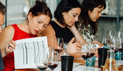 Cheryl Wakerhauser (left) and Anne Cline study the materials and wines during class.