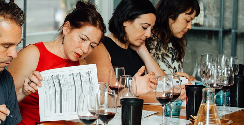 Cheryl Wakerhauser (left) and Anne Cline study the materials and wines during class.