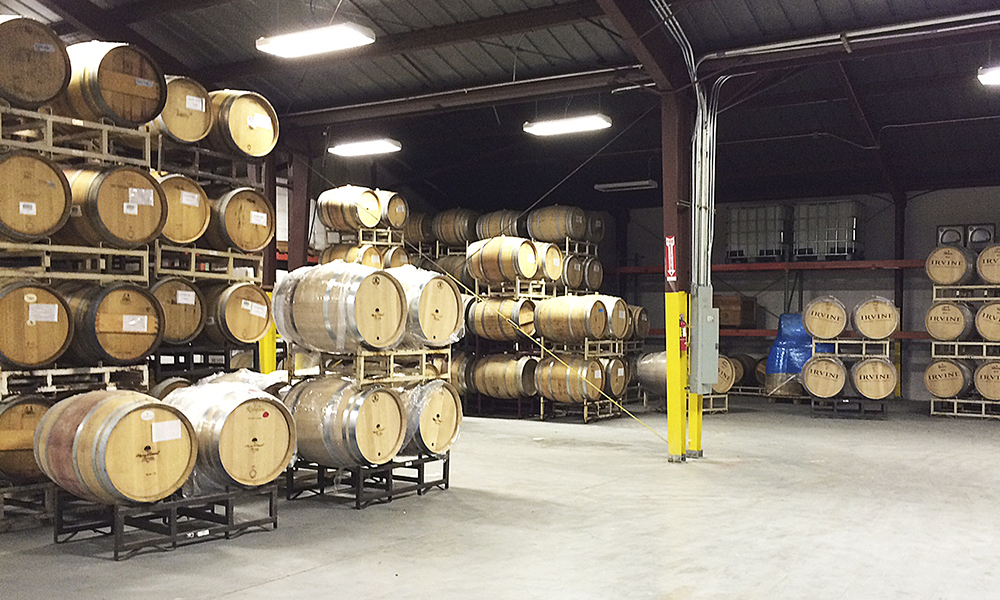 Barrels are stacked high at the newly expanded Pallet Wine Company facility in downtown Medford. Pallet has grown from 900 cases of wine for seven clients its first year to producing more than 30,000 cases for 20-plus clients during the 2014 harvest.##Photo provided