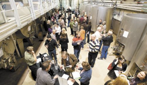 Attendees at this year’s ¡Salud! Big Board Barrel Auction flock to the tables of participating wineries
pouring their 2009 Pinot Noirs at Domaine Drouhin Oregon in Dayton. Photo by Marcus Larson.