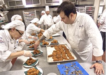 Host chef Rocky Maselli (right) prepares pheasant and ham croquettes with fired Oregon black truffle at last year’s Grand Dinner with help from the staff from the Lane Community College Culinary Institute. Photo by David Barajas. Host chef Rocky Maselli (right) prepares pheasant and ham croquettes with fired Oregon black truffle at last year’s Grand Dinner with help from the staff from the Lane Community College Culinary Institute. Photo by David Barajas.