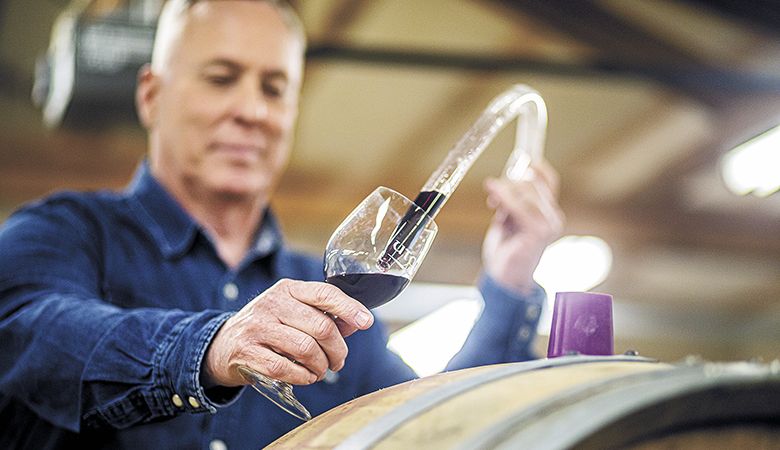 Photographer
Jason
Kaplan captures
Dan Warnshuis of
Utopia Vineyard
checking on his
Pinot Noir at the
Newberg winery.