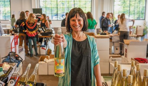 Cristina Gonzales, owner and winemaker of Gonzales Wine Company, holding a bottle of her wine. ## Photo by Nick Trombetta