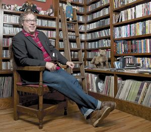 Matt Brown of Bladen County Records relaxes with a glass of wine in front of a massive CD collection belonging to his roommate, Issac Brock of Modest Mouse.