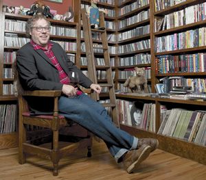 Matt Brown of Bladen County Records relaxes with a glass of wine in front of a massive CD collection belonging to his roommate, Issac Brock of Modest Mouse. Matt Brown of Bladen County Records relaxes with a glass of wine in front of a massive CD collection belonging to his roommate, Issac Brock of Modest Mouse.