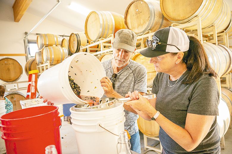 Two participants straining Trousseau grape juice. ## Photo provided by Analemma Wines Two participants straining Trousseau grape juice. ## Photo provided by Analemma Wines
