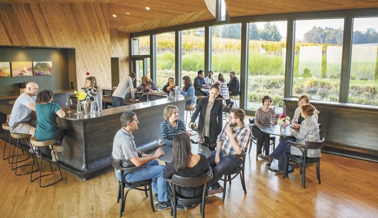 A pre-pandemic crowd gathers at Sokol Blosser Winery tasting room, which features dramatic architecture and top-rate hospitality. ABOVE: Sokol Blosser Pinot Noir. ##Photo provided