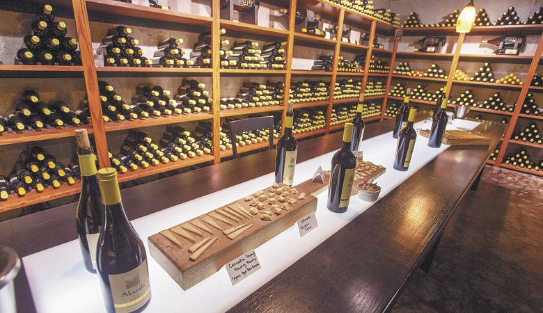 A private tasting at Abacela reveals the iconic yellow-foiled bottles and an assortment of fine cheese. ##Photo by Andrea Johnson