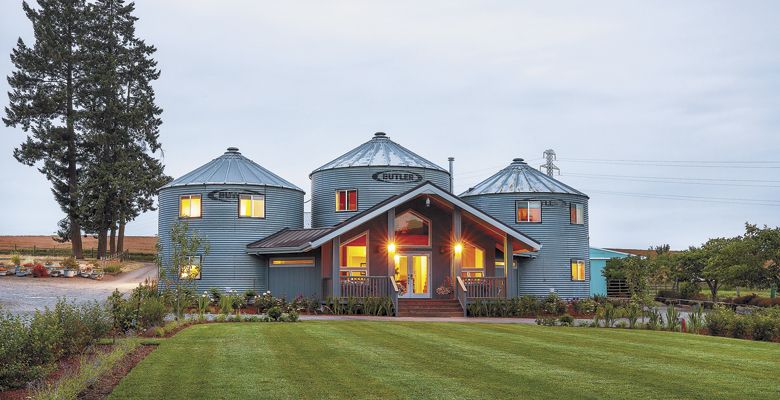 The silo suites glow from the inside as the sun sets at Abbey Road Farm. ##Photo by Kathryn Elsesser