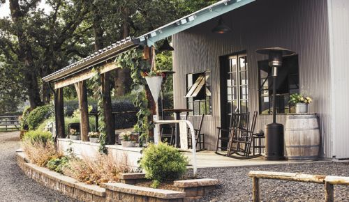 Abbey Road Farm’s new tasting room nestles under towering oaks on the sprawling property; guests can taste a number of brands inside. ##Photo by Kathryn Elsesser