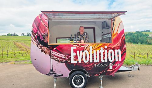 Alex Sokol Blosser serving wine from his winery’s new mobile wine bar. ## Photo provided by Sokol Blosser Winery