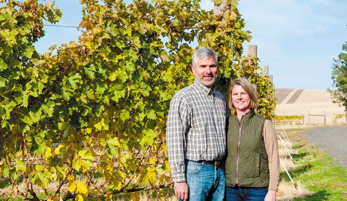 JJ and Kelly Menozzi. Aluvé s Kelly and JJ Menozzi standing in their Walla Walla Valley vineyard. ## Photo by Richard Duval