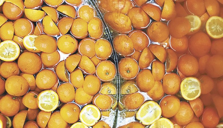 A truckload of oranges steeping in a few hundred gallons of Viognier, Chardonnay and brandy. “We pull the lid off and give them a stir a few times during their tank time,” says Morrow. ##Photo by Stuart Perkins