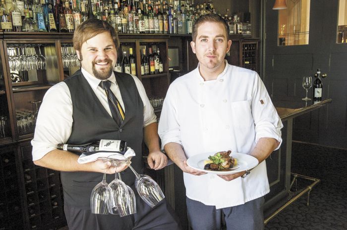 Executive Chef Billy Busher (right) and sommelier Drew Gibbs take care of their loyal customers at Alchemy inside The Winchester Inn. Photo by Andrea Johnson. Executive Chef Billy Busher (right) and sommelier Drew Gibbs take care of their loyal customers at Alchemy inside The Winchester Inn. Photo by Andrea Johnson.