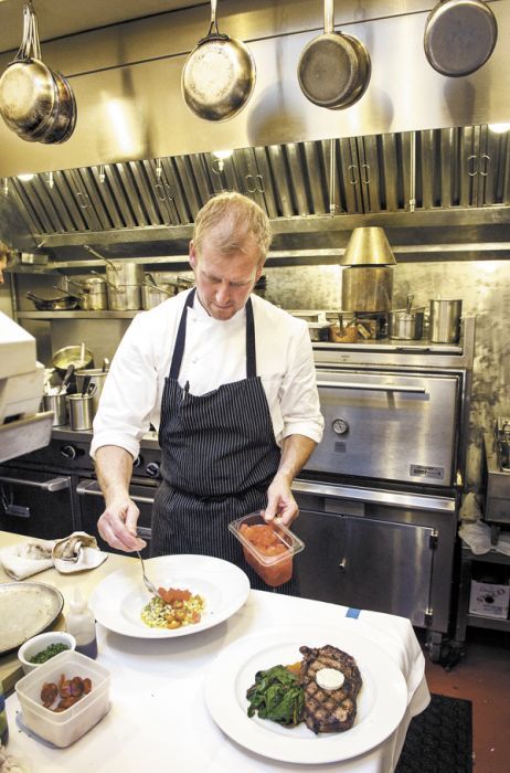 Chef Erik Brown garnishes an entrée at Amuse Restaurant in Ashland. Photo by Andrea Johnson. Chef Erik Brown garnishes an entrée at Amuse Restaurant in Ashland. Photo by Andrea Johnson.