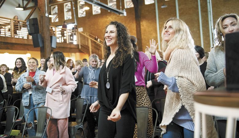 Diana Blank of Work Life Essentials and Nikki Cloud
of 4 Elements Yoga get up and move with the crowd. ##Photo by Carolyn Wells-Kramer