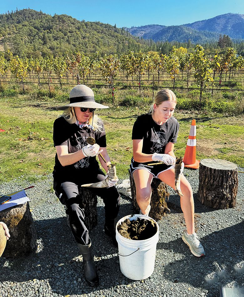 Two women filling cowhorns with manure. The horns were buried in the early fall and dug up six months later. ## Photo provided by Troon Vineyard