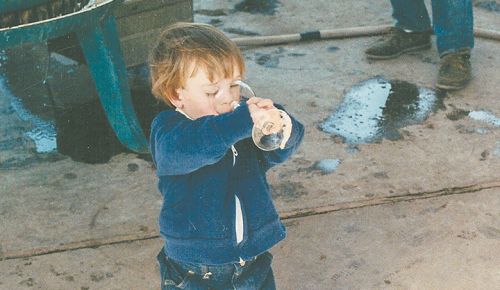 Sager Small sipping fresh grape juice during harvest. Taken during the late  80s at Woodward Canyon Winery, Small is now vineyard manager and winery co-owner. ##Photo courtesy of Woodward Canyon Winery