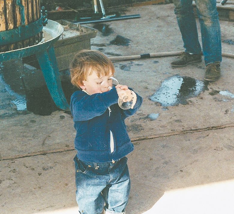 Sager Small sipping fresh grape juice during harvest. Taken during the late 80s at Woodward Canyon Winery, Small is now vineyard manager and winery co-owner. ##Photo courtesy of Woodward Canyon Winery Sager Small sipping fresh grape juice during harvest. Taken during the late 80s at Woodward Canyon Winery, Small is now vineyard manager and winery co-owner. ##Photo courtesy of Woodward Canyon Winery