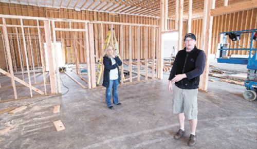 Caroline Biggio Hamina listens as Todd Hamina describes the layout of their new facility, which is currently under construction. Photo
by Marcus Larson.