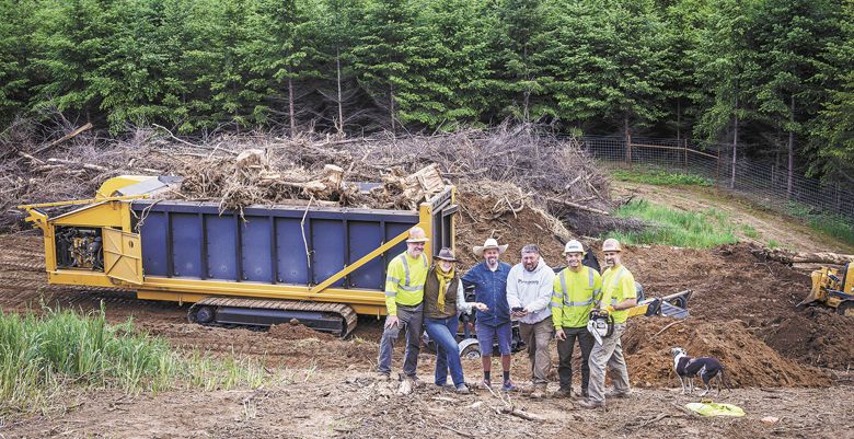 Standing near the Carbonator-500 (from left) on location near Gaston: Brian Beall, Blackwood Solutions; Clare Carver and Brian Marcy, Big Table Farm; Rick Webb, Sam Conrad and Jason Feagans, Blackwood. ##Photo by Andrea Johnson