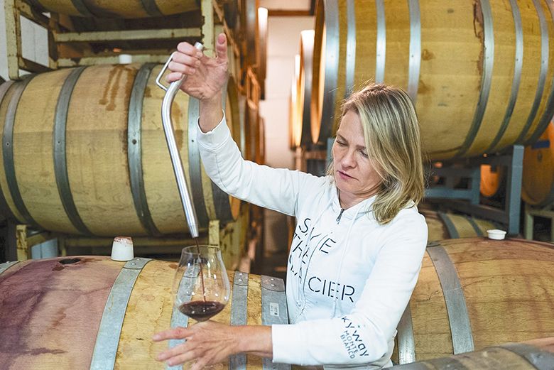 Day Wines&rsquo; founder and winemaker Brianne Day using a thief to sample wine from a barrel. ## Photo by Benjamin Amberg