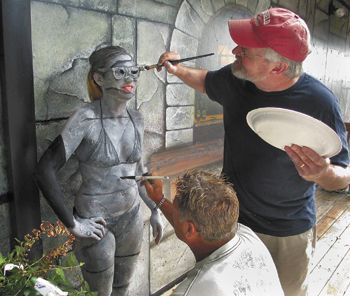John Stromme (right) and Eddie Johnson paint Youngberg Hill assistant winemaker Ariel Eberle to look like the mural behind her at the McMinnville winery. John Stromme (right) and Eddie Johnson paint Youngberg Hill assistant winemaker Ariel Eberle to look like the mural behind her at the McMinnville winery.