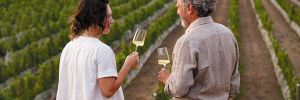 Brooke Delmas Robertson standing in family-owned SJR Vineyard with father Steve Robertson. ## Photo provided by Delmas