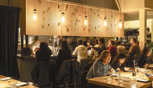 Diners enjoying an evening meal at Portland&rsquo;s Caf&eacute; Rowan. ## Photo by Evan Sung