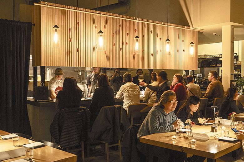 Diners enjoying an evening meal at Portland&rsquo;s Caf&eacute; Rowan. ## Photo by Evan Sung