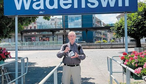 Dan Chapel, owner of Cardwell Hill Cellars, holding a bottle of his wine while standing under a sign in Wädenswil, Switzerland. ## Photo provided by Cardwell Hill Cellars