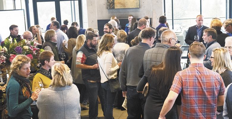 Guests taste the custom-made 2016 Pinots, taking notes before the Big Board Auction begins. ##Photo by Andrea Johnson