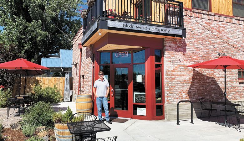 Kirk Ermisch, owner of Elixir Wine Group, stands in front of his storefront in Bend. ##Photo by Patty Mamula