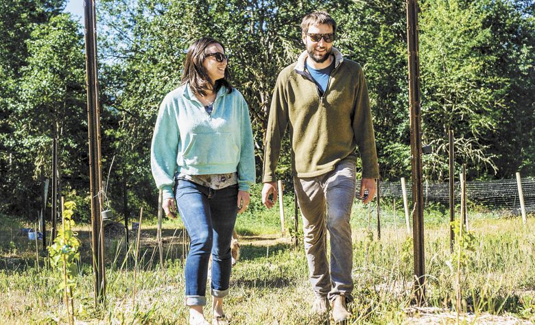 Jure Poberaj and Nina Jimenez in their newly planted vineyard in the hills above White Salmon, Washington. ##Photo by Joshua Chang