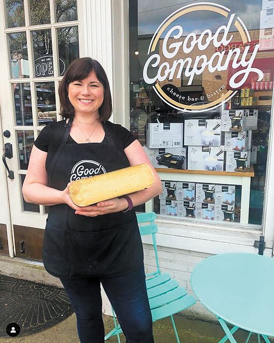 Kristen Kidney, owner of Good Company Cheese Bar & Bistro in Newberg, holding a wheel of aged goat Gouda.##Photo credit: Good Company Cheese Bar & Bistro