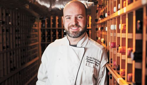 Chef Chris Czarnecki at the Joel Palmer House, standing in his restaurant’s wine cellar. ##Photo Provided