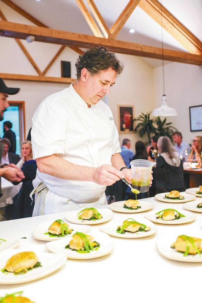 Chef Michael Anthony prepping dishes during a recent Nicolas-Jay dinner. ## Photo provided by Nicolas-Jay