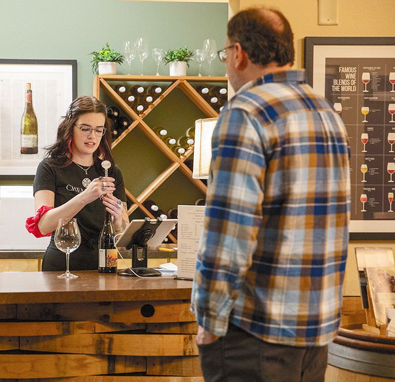 A student opening a bottle of wine during Chemeketa s Nouveau Release Party. ## Photo provided by Chemeketa Community College