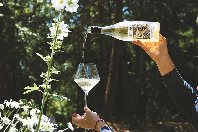 Remy Drabkin, Remy Wines&rsquo; owner and winemaker pouring a glass of white wine. ## Photo by Cheryl Juetten