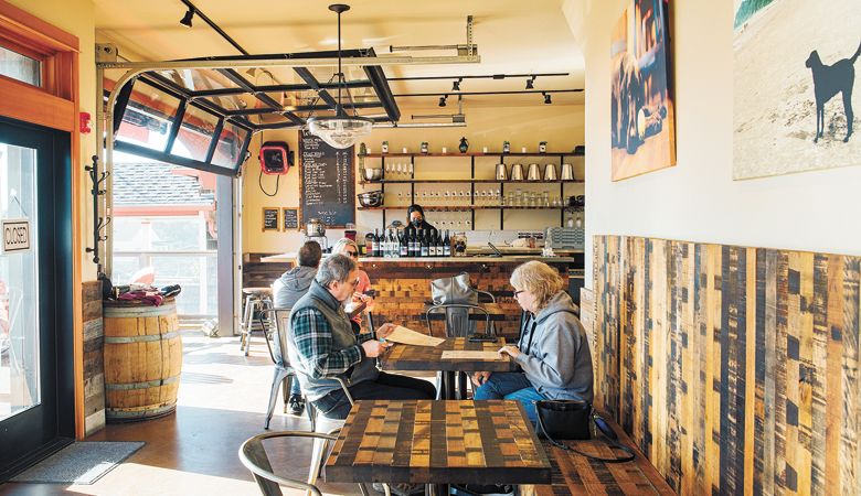 Guests sit down
for a glass of wine
and food at The
Winery at Manzanita.##Photo by Kathryn Elsesser