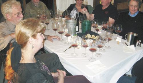 Participants in the 1985 Oregon Pinot tasting included co-host Judy Erdman (foreground), Amity Vineyards founder Myron Redford (behind Erdman) and Erath Vineyards founder Dick Erath (to Redford’s left), among others. The group gathered at Erdman’s home in Portland. Photo by Karl Klooster.