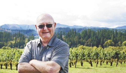 Bill Fuller stands among the vines he planted at Tualatin Estate Vineyard in 1973. Photo provided.