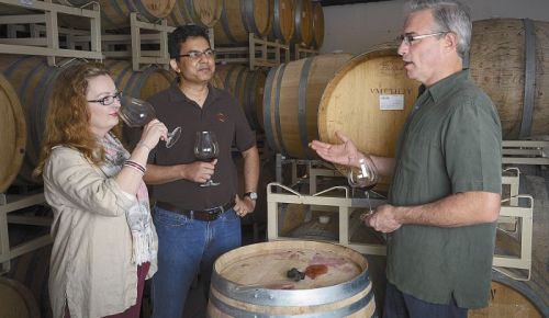 Tony Rynders discusses wine with Saffron Fields owners Sanjeev Lahoti and Angela Summers. Rynders is the red winemaker for the Yamhill-Carlton winery. Photo by Andrea Johnson